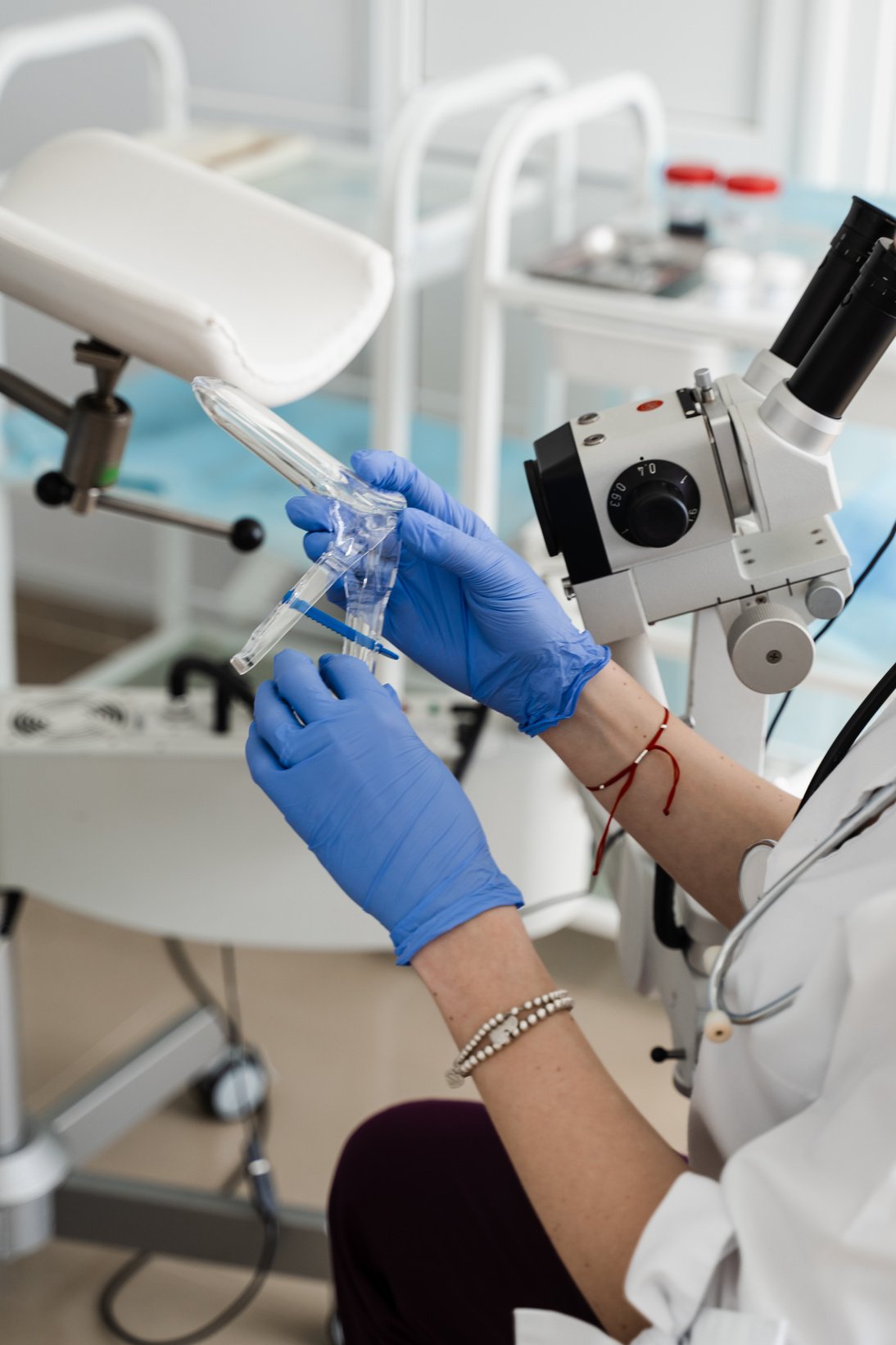 Speculum close-up in gynecologist hands for colposcopy procedure to closely examine cervix, vagina and vulva of girl in gynecology clinic.